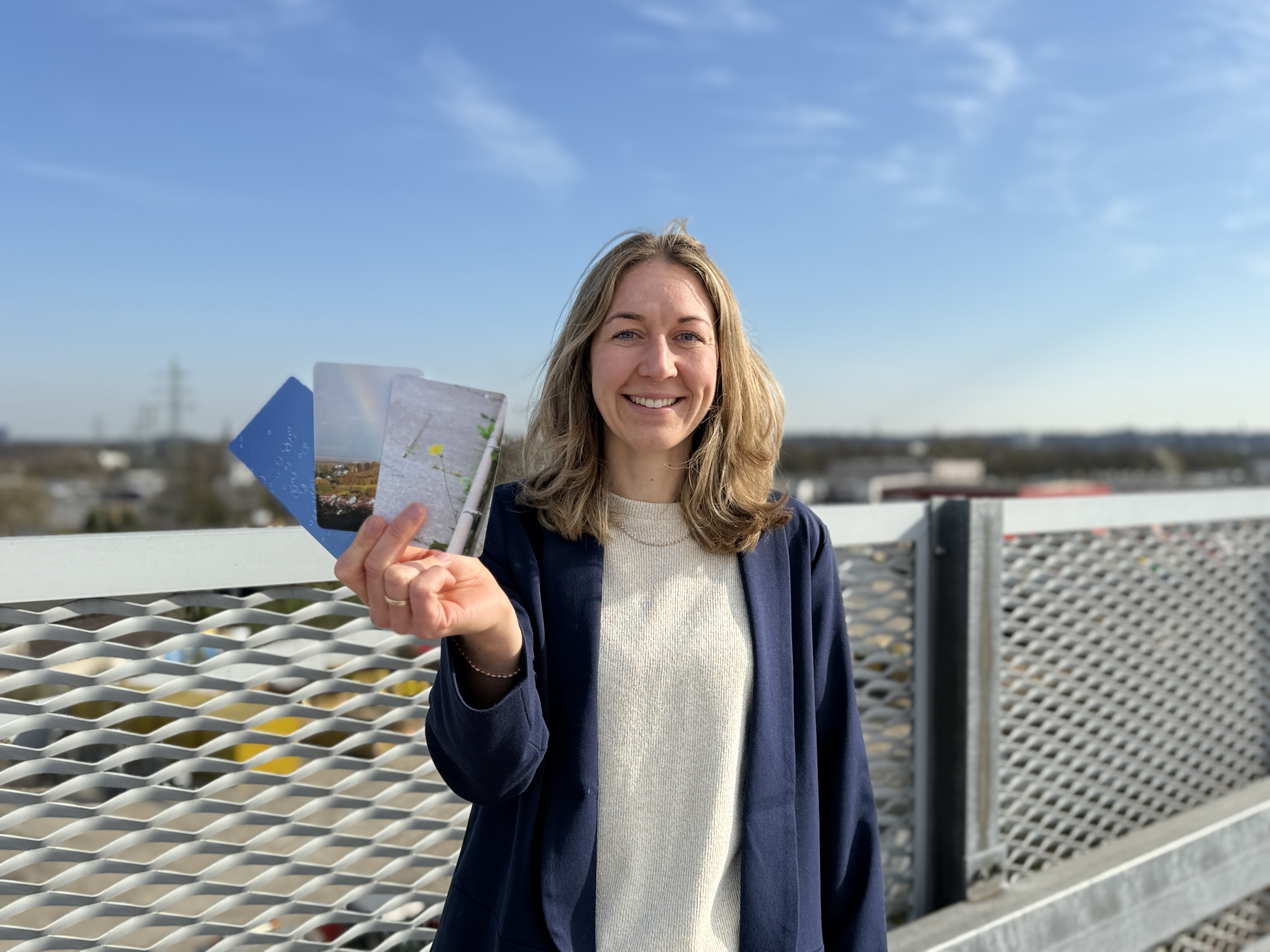 Ann-Kathrin Fuest steht auf dem Parkdeck und hält Karten in die Kamera.
